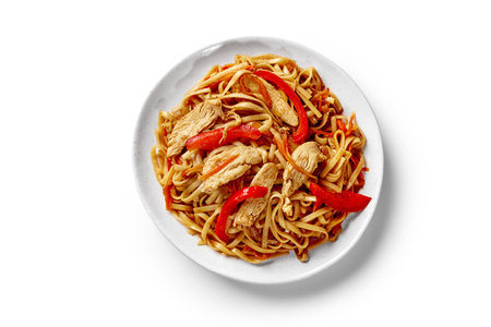 Plate of spicy stir fried udon noodles with beef, bell peppers and carrotsの写真素材