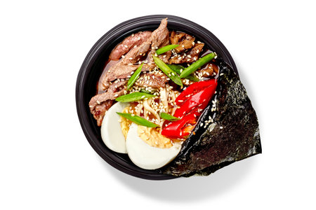 Spicy ramen soup with noodles, beef, shiitake mushrooms, boiled egg, red hot pepper, green onion,...