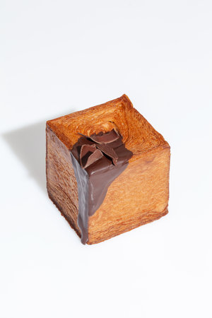 Freshly baked cubic croissant with chocolate topping and dark chocolate chipsの写真素材