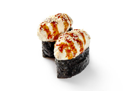 Two gunkan maki with eel topping dressed with unagi sauce and sesameの写真素材
