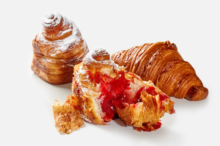 Flaky croissant and cube shaped cruffins with berry fillingの写真素材
