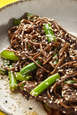 Asian stir-fried soba noodles with beef and green beans