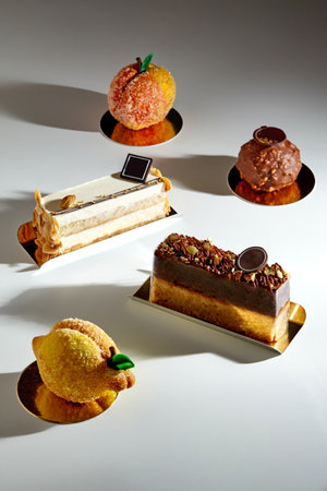 Variety of handcrafted desserts on light surface