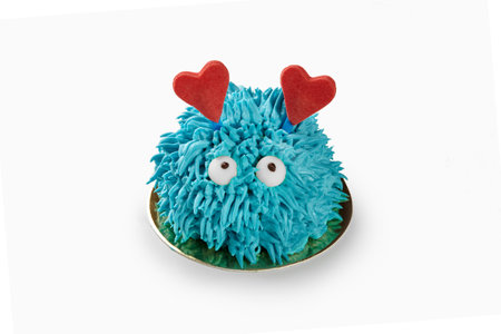 Blue furry monster cake showing love with two red heartsの写真素材