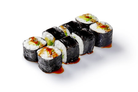 Delicious sushi rolls with eel, avocado, and unagi sauce drizzled on white backgroundの写真素材