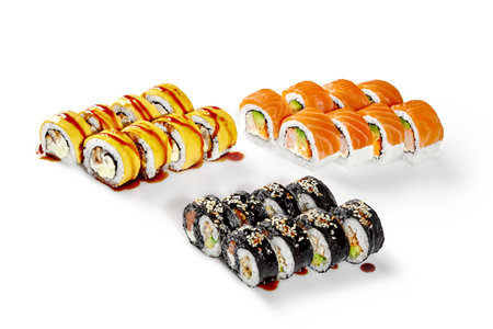 Sushi rolls covered with sesame and topped with sauce presenting variety of japanese foodの写真素材