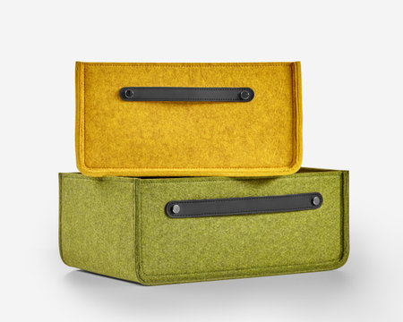Two stylish felt storage boxes with leather handles creating modern organization