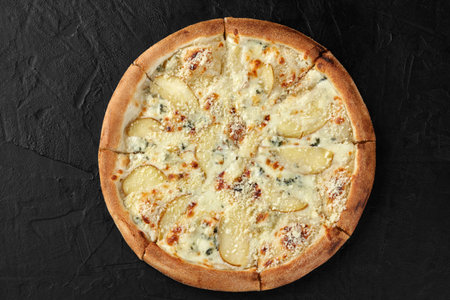Delicious pizza with pears and blue cheese on black backgroundの写真素材