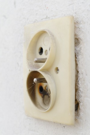 burnt electrical plug in the wall