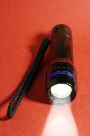 pocket torch light on a red backgroundの写真素材