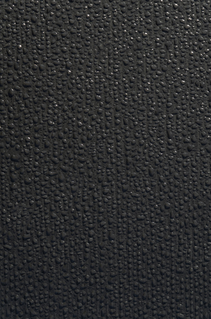 closeup a wet black tarpaulin after rainの写真素材
