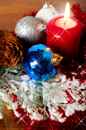 Christmas decoration with burning candle and shining baublesの写真素材