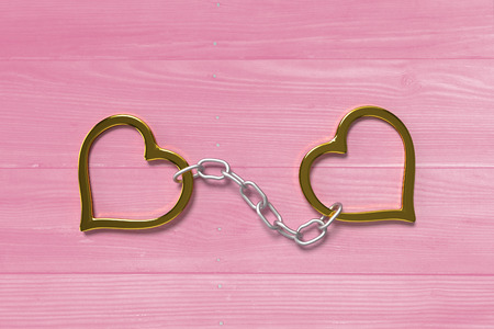 golden love handcuffs on the pink bright planksの写真素材