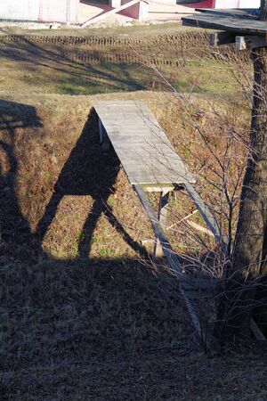 old damaged wooden footbridge over the dried creekの写真素材