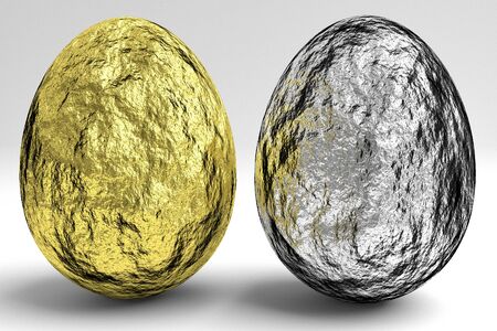 gold and silver easter eggs made of metal foil on the white backgroundの写真素材
