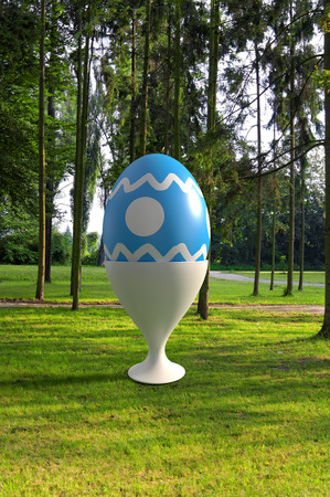 big 3d rendered easter egg standing in the parkの写真素材