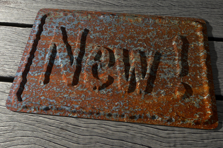 old rusty brass with the "new !" inscription, 3d renderingの写真素材