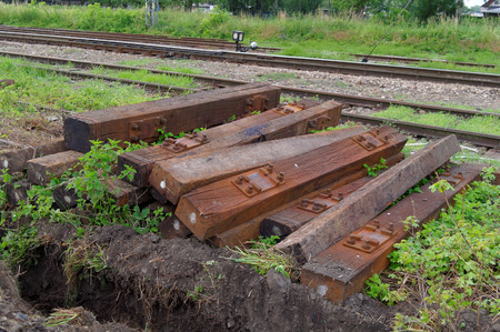 stacked old used wooden sleepers beside the railwayの写真素材