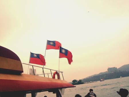 Taiwan flags fluttering in the glow of sunset