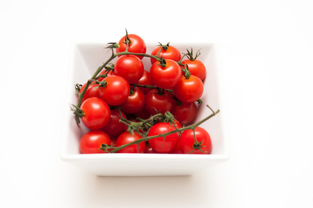 Ripe vine tomatoes on a white isolated background close upの写真素材