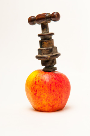 Old style tap in an appleの写真素材