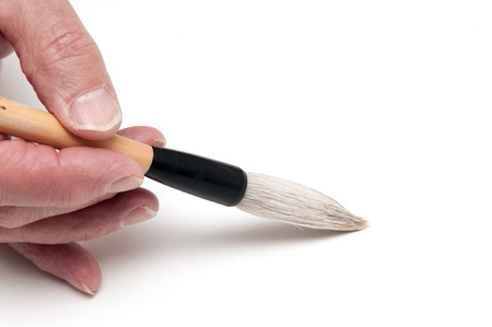 Man using a calligraphy brush with space to add textの写真素材