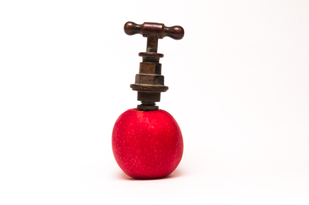 Old style tap in an appleの写真素材