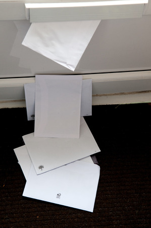 Unopened mail pilied up on the door matの写真素材
