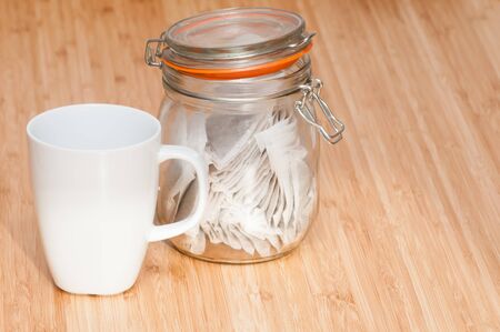 Tea cup with caddy on a wooden breakfast tableの写真素材