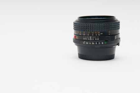 Vintage style anaolg fifty millimetre prime lens on a white backgoundの写真素材