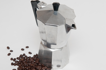 coffee beans in the foreground with espresso makerの写真素材
