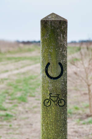 Sign post showing the way for cyclists on a country pathの写真素材