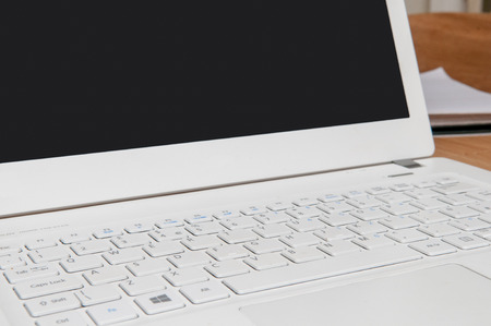 Laptop and notepad on the tableの写真素材