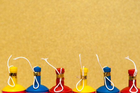 Colorful party poppers arranged in a row on a bright background
