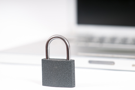 laptop computer being protected from online cyber crime and hackingの写真素材