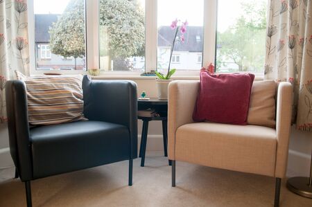 Interior of a neutral colored living room with two armchairsの写真素材
