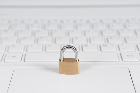 laptop computer being protected from online cyber crime and hackingの写真素材
