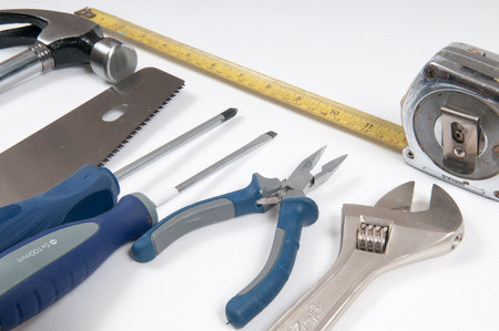 variety of tools for diy or home improvement arranged on a white background