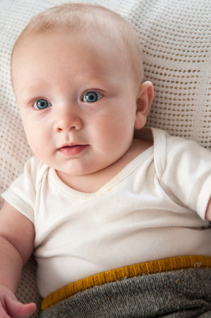 baby boy on white blanketの写真素材