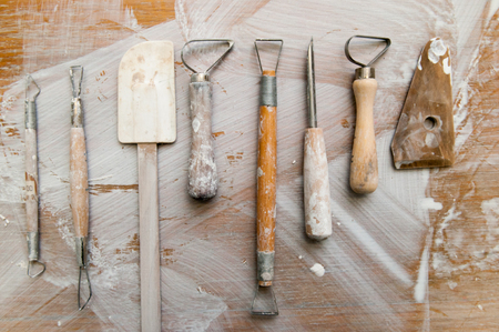 Work tools in a messy ceramics workshop, overhead viewの写真素材