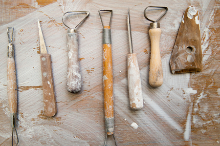 Work tools in a messy ceramics workshop, overhead viewの写真素材