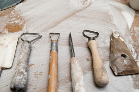 Work tools in a messy ceramics workshop, overhead viewの写真素材