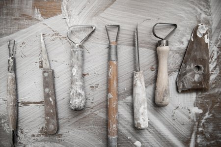 Work tools in a messy ceramics workshop, overhead viewの写真素材