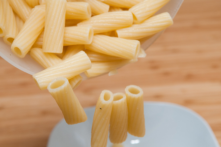 cooking fresh pasta in a pot on the hobの写真素材