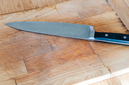 empty chopping board for food preparation with knife