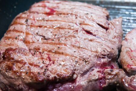Steak dinner cooking on the grillの写真素材