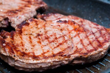 Steak dinner cooking on the grillの写真素材