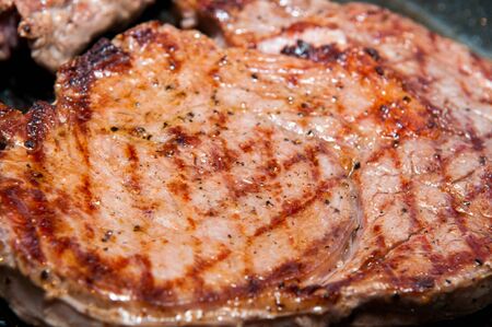 Steak dinner cooking on the grillの写真素材