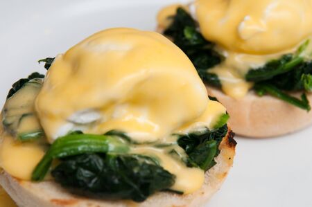 Eggs benedict or eggs florentine on a white plateの写真素材