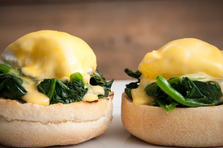Eggs benedict or eggs florentine on a white plateの写真素材